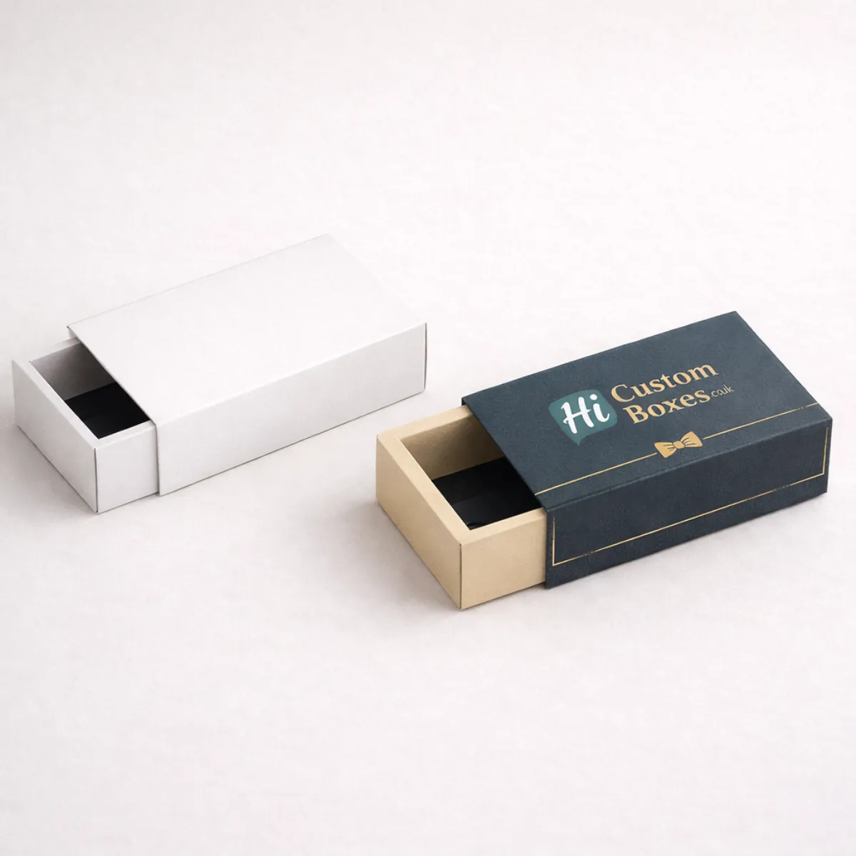 Two sliding drawer-style matchbox gift sets in plain white and branded navy blue colours- class=
